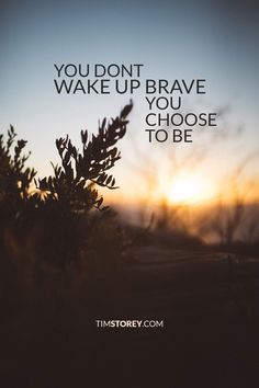 the words you don't wake up brave you choose to be on a sunset background