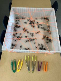 a box filled with lots of different colored toothbrushes on top of a table