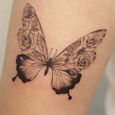 a black and white photo of a butterfly with roses on it's back side