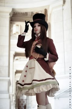 a woman in a dress and top hat posing for the camera with her hands on her hips