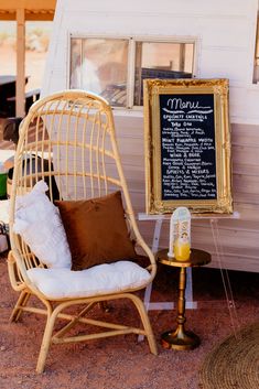 a white chair sitting in front of a chalkboard on the side of a trailer