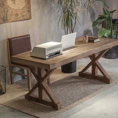 a computer desk with a laptop and printer on it