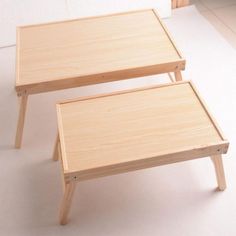 two wooden tables sitting next to each other on top of a white tile floor in front of a window