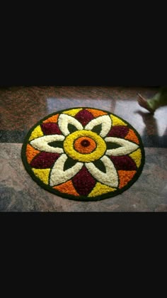 a colorful flower design is on the floor