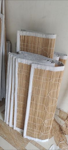 several pieces of wicker stacked on top of each other in a room with tile flooring