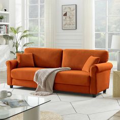 an orange couch in a white living room