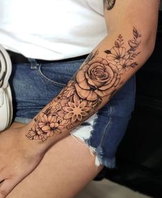 a woman with a flower tattoo on her arm