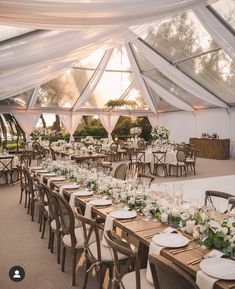 an outdoor tent with tables and chairs set up for dinner