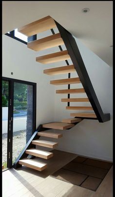 a stair case with wooden treads in a house