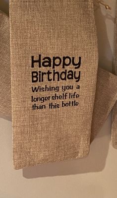 a burlap birthday card hanging on a clothes line with the message happy birthday wishing you a longer selfie than this bottle