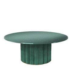 a round table with a green base and gold dots on the top, against a white background