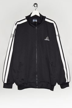 "Vintage 90's 00's Adidas track jacket in black with three stripes in white. - Size tag: Please always check measurements before buying. Men's L - Measurements (laying flat): Pit to Pit: 25.5\" Length: 28.5\" Sleeve: 23\" Pit to Cuff: 20.5\" Across the shoulders: 23.5\" -Wear: /Please see images for details/ Good used condition. Small rip on the sleeve as shown on the picture. - Fabric: Polyester *All of our items are preloved pieces so some signs of natural wear and age are to be expected. Plea Adidas 90s Coat, Casual Track Jacket With Contrast Stripes For Streetwear, Side Stripes Track Jacket For Fall Streetwear, Fall Streetwear Track Jacket With Side Stripes, Sportswear Outerwear With Contrast Stripes For Streetwear, Winter Streetwear Track Jacket With Side Stripes, Contrast Stripes Outerwear For Streetwear, Winter Streetwear Track Jacket With Three Stripes, Fall Track Jacket With Contrast Stripes For Streetwear