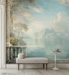 a wall with a painting on it and a bench in the foreground, next to a table