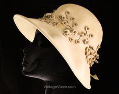 "Ladies fedora style hat with such sophisticated chic from the 1960s, in a designer version by world-renowned milliner Mr. John. It's a chic neutral hat with an elegantly floppy brim that can be turned up or down. Has a soft creased crown and marvelous felt \"vines\" dotted with enamel studs. Measurements 21 1/8 Inches Circumference at inside base of crown, Height of Crown approx 4 1/2 Inches, Brim 3 1/8 Inches at Center Front Era 1960s Label ' NEW YORK PARIS / Mr. John / CLASSIC ' at inside bac Beige Fitted Felt Hat For Summer, Fitted Beige Felt Hat For Summer, Summer Beige Fitted Felt Hat, Vintage Beige Fedora Felt Hat, Vintage Fitted Beige Felt Hat, Fitted Retro Cream Hat, Elegant Cream Felt Hat For Summer, Formal Brimmed Felt Hat For Spring, Fitted Cream Cloche Hat With Curved Brim