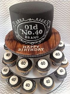 a birthday cake made to look like an old no 40 brand hat on top of cupcakes