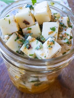 a glass jar filled with food on top of a wooden table