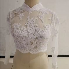 a mannequin wearing a white lace top