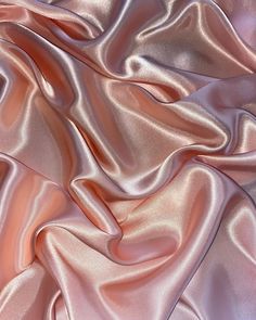 a close up view of a pink satin fabric