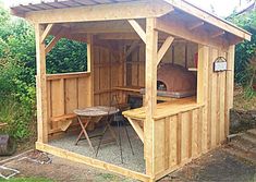 a small wooden structure with a grill in it