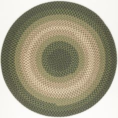 a round rug with an oval design in green and beige colors on a white background