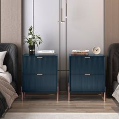 two blue nightstands with books on them in a bedroom