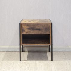 a small wooden table sitting on top of a hard wood floor next to a wall