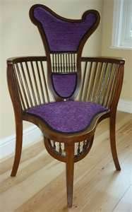 a purple chair sitting on top of a hard wood floor