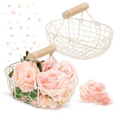 two pink roses in a white basket next to some string and wood spools