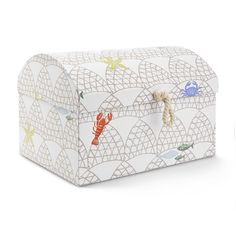 a white box with lobsters on it and rope around the lid, sitting on a white surface