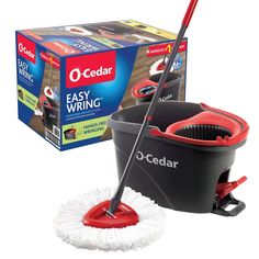 a red and black mop sitting next to a box of o - cedar easy wring