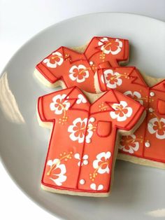 cookies decorated with orange and white designs on a plate