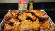 chicken wings in tin foil with condiments and seasoning sitting on the counter