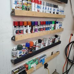 the wall is filled with many different types of paint and other things to use on it