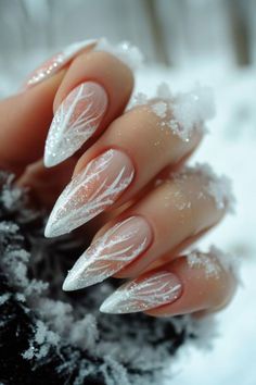 These almond-shaped nails feature a soft white gradient complemented by a delicate snowflake-like design. The glittery accents add a frosty touch, perfect for evoking that winter wonderland vibe. The use of gel polish ensures a flawless and glossy finish. These nails pair beautifully with cozy knits and are ideal for classy winter events or even a romantic date night. Christmas Nails Sparkling, White Silver Winter Nails, Wedding Nails Blue And Silver, Blue Frost Nails, Winter Frost Nails, Jack Frost Nails, Icy Nail Designs, White And Blue Winter Nails, Frosty Blue Nails