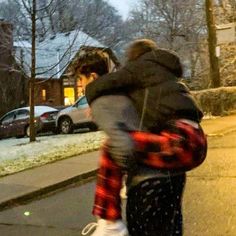 two people walking down the street in winter