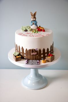 a white cake decorated with an image of a rabbit on top