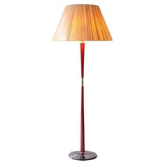 a lamp that is sitting on top of a table with a light shade over it