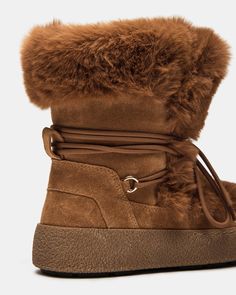 Expertly designed for both style and function, the AVALANCHE ankle boot will keep you warm and on-trend. The bootie style offers comfort and support, while the faux fur adds a touch of luxury. The platform adds height and stability, making these boots perfect for all-day wear. 1.5 inch heel height 15.5 inch shaft circumference 6.25 inch shaft height Suede and faux fur upper material Faux fur lining Faux fur sock Synthetic sole Fit tip: If you are in between sizes, size down a half-size Imported Brown Winter Boots With Plush Lining, High-top Shearling Winter Boots, High-top Shearling Boots For Winter, Winter High-top Shearling Boots, Trendy Winter Boots With Faux Fur Lining, Winter Shearling Boots With Lug Sole, Winter Platform Boots With Faux Fur Trim, Winter Suede Boots With Faux Fur Lining, Winter Faux Fur Platform Boots With Round Toe