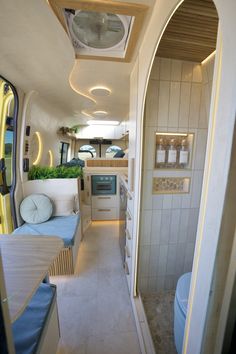 an interior view of a bus showing the kitchen and living room