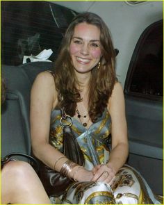 a woman sitting in the back seat of a car with her hand on her purse