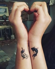 two people with matching tattoos on their arms