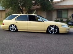 a yellow car parked in front of a house