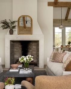 a living room filled with furniture and a fire place in front of a painting on the wall