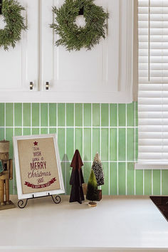 a kitchen counter topped with christmas decorations and a sign