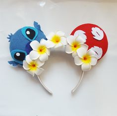 two headbands decorated with flowers and fish on top of each other in the shape of an egg