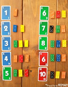 a wooden table topped with lots of colorful numbers and dominos on it's sides