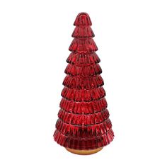 a red glass christmas tree sitting on top of a table