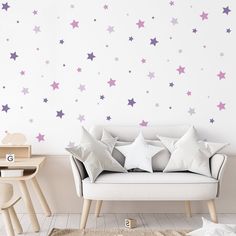 a living room filled with furniture and stars on the wall behind it is a white couch