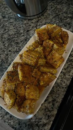 grilled corn on the cob in front of an air fryer