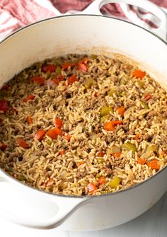 a pot filled with rice and vegetables on top of a table